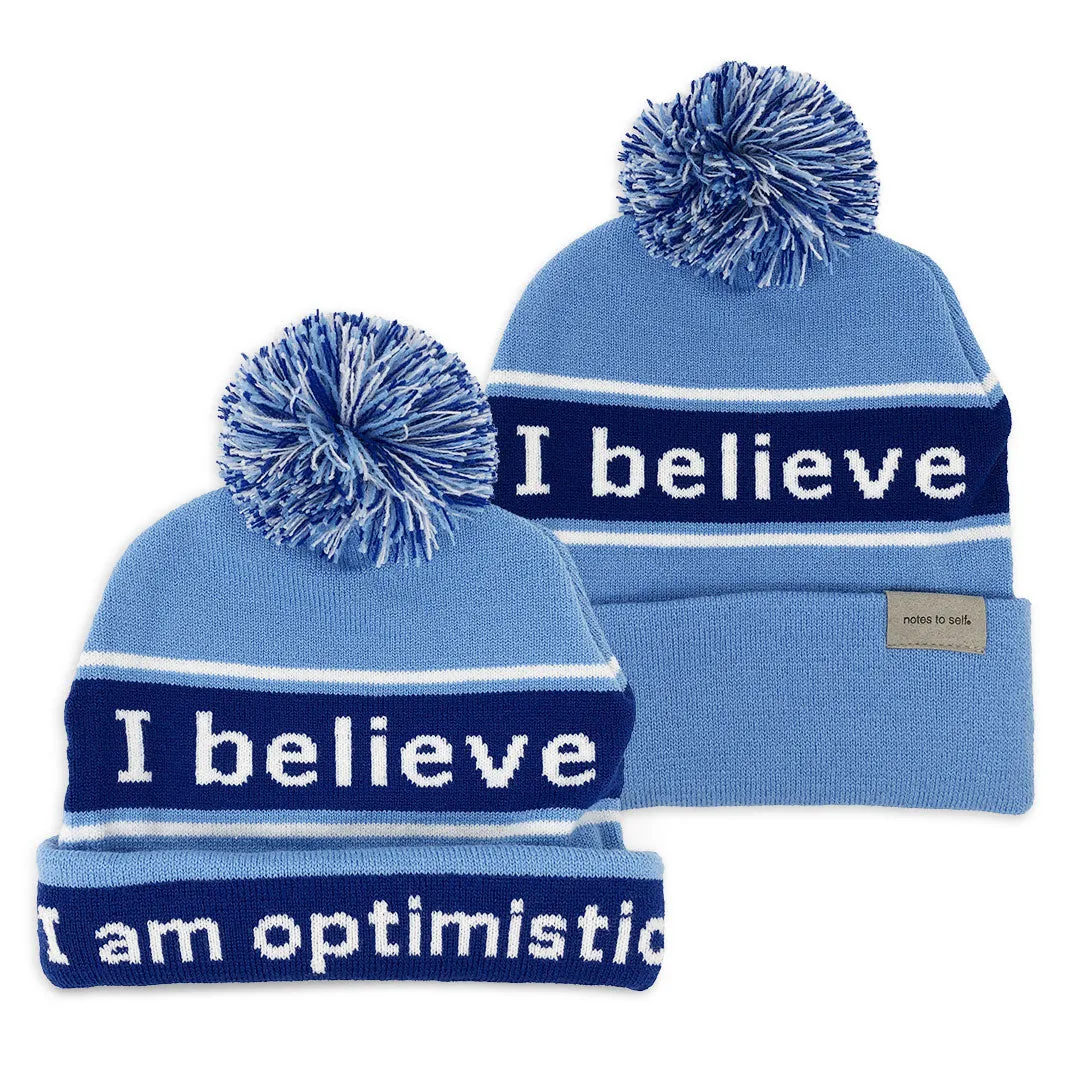 I believe™ blue knit beanie with I am optimistic™ on inside cuff