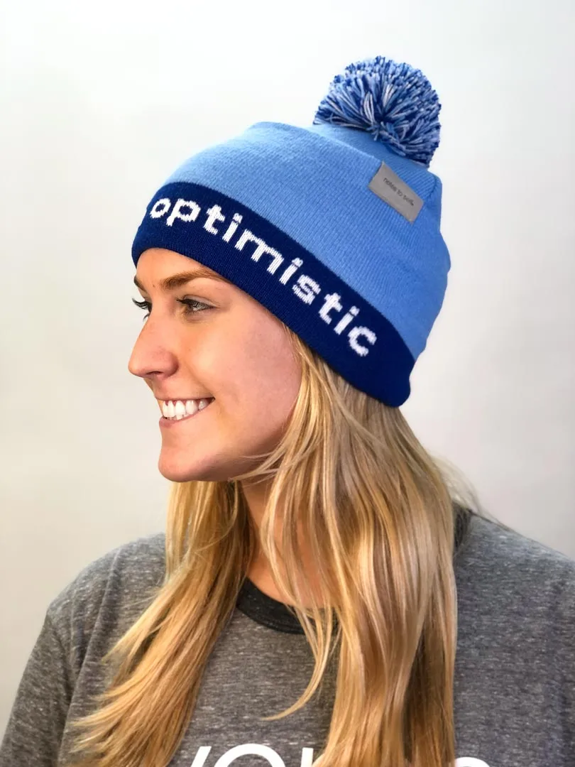 I believe™ blue knit beanie with I am optimistic™ on inside cuff