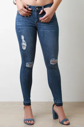 Mid Rise Distressed Raw Hem Skinny Jeans